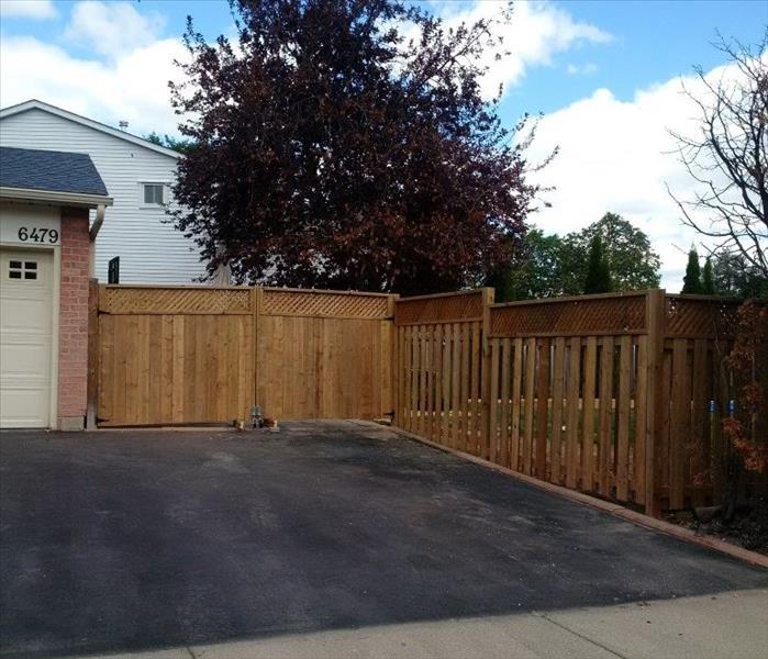 fence rebuilt by driveway