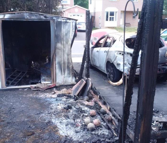garden shed, fence and car burned after a fire