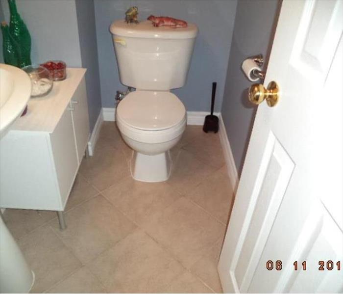 bathroom toilet with completed drywall and trim